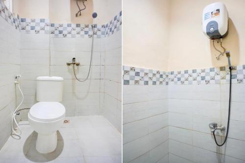 a bathroom with a toilet and a shower at OYO 94680 Ralica Residence in Medan