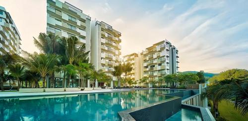 an image of a swimming pool at a resort at By The Sea Penang in Batu Ferringhi