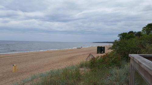 a beach with a trashcan sitting on the sand at Saulrieti in Saulkrasti