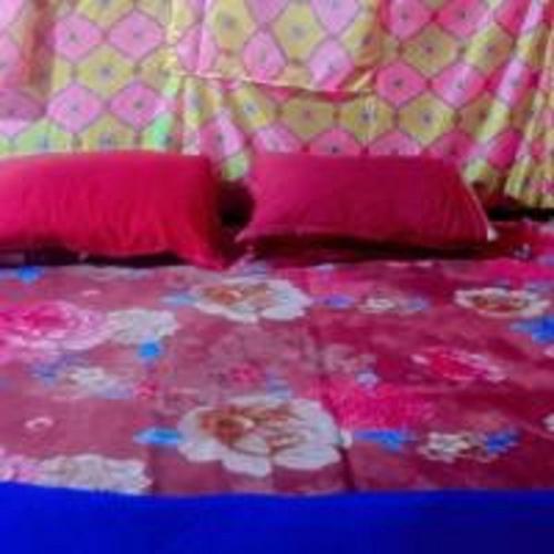 a pink bed with pink pillows and pink sheets at G J Adventure Camps By StayApart in Shivpuri