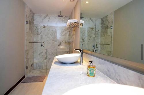 a bathroom with a bowl sink and a shower at Punta Mita Beachfront Ocean Views BOLONGO in Higuera Blanca