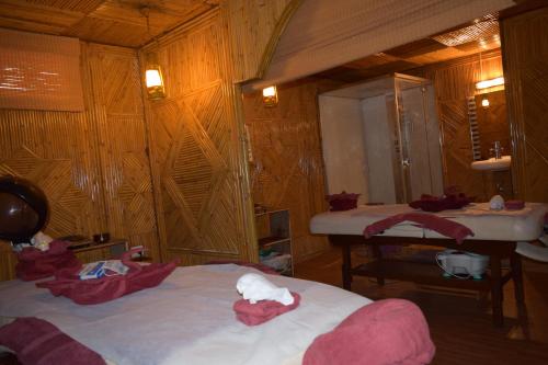 a bedroom with a bed and a sink in it at Hotel Raj Palace in Rishīkesh