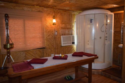 a room with a table in a wooden room at Hotel Raj Palace in Rishīkesh