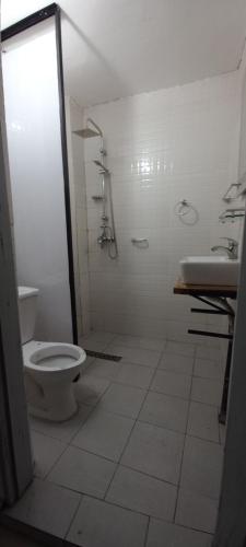 a bathroom with a toilet and a shower and a sink at Résidence 5ème Ciel in Douala