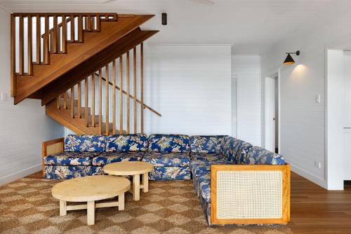 a living room with a blue couch and a table at The Cleeves in Federal
