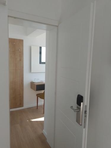 a sliding door leading into a room with a table at Beach Hotel Božikovina in Podstrana