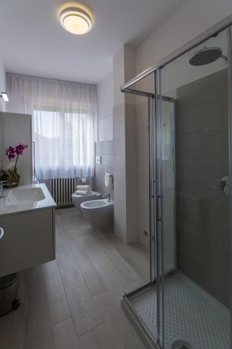 a bathroom with a shower and a sink and a toilet at St. Vitale’s Basilic view elegant apartment in Ravenna