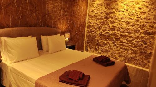 a bedroom with a bed with two towels on it at Casa Stratigos in Corfu