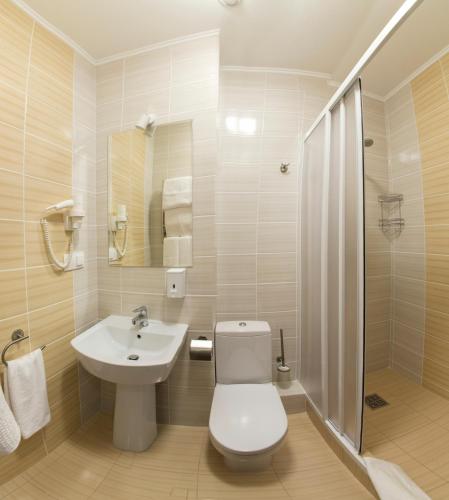 a bathroom with a toilet and a sink at Hotel Florida in Kyiv
