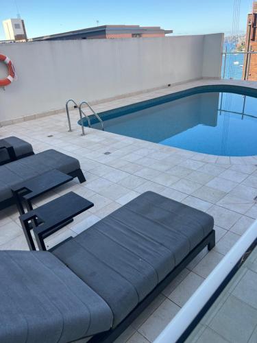 a swimming pool on top of a building at Harbourside Apartment in Sydney