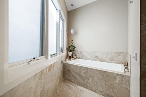 a bathroom with a large tub and a window at Great Ocean Road Sunrises in Lorne