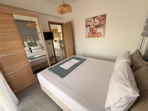 a small bedroom with a bed and a bathroom at Andromachi's House in Pefkochori