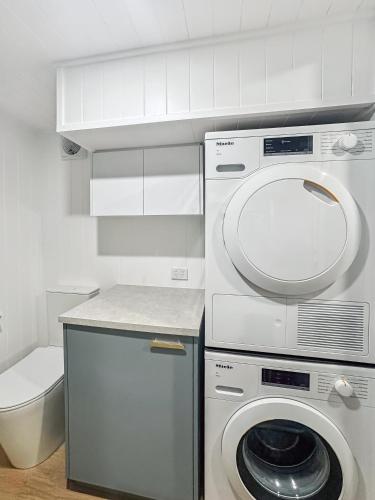 a kitchen with a washing machine and a washer at Wuelf & the Fallow in Moonbah