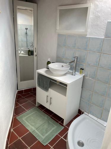 a bathroom with a sink and a toilet at Maison cœur de ville in Pertuis
