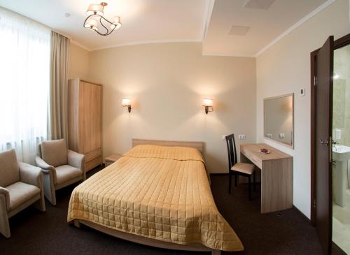 a hotel room with a bed and a desk and chair at Hotel Florida in Kyiv