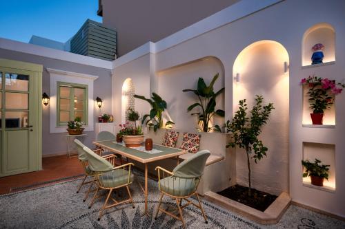 a living room with a table and chairs at Siliguri Traditional House in Rhodes Town
