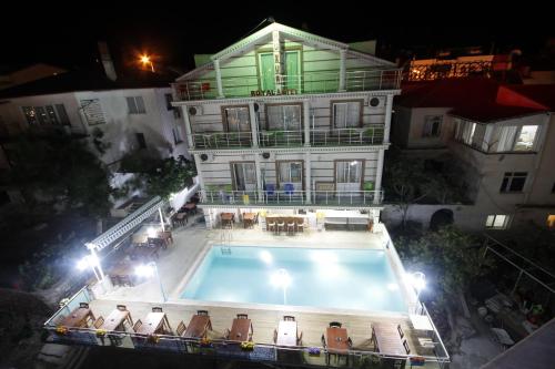 a large building with a swimming pool in front of it at Huzur Royal Hotel in Datca