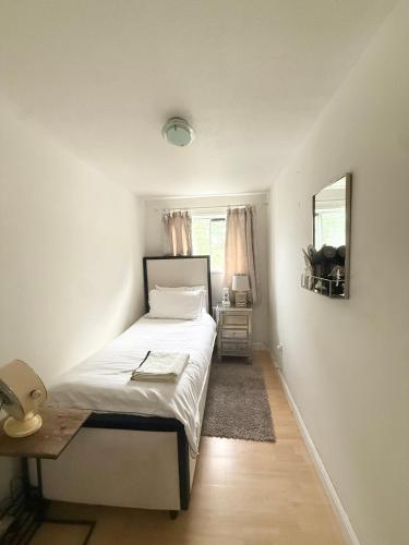 a bedroom with a bed and a table and a mirror at Pendleton Valley in Peterborough