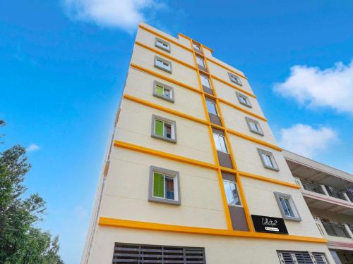 a tall building with many windows on the side of it at Collection O Sarjapura Formerly Blissful Stays in Bengaluru
