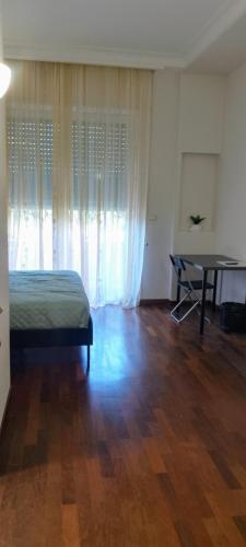 a bedroom with a bed and a table in it at Alloggio Turistico Casa Vela in Anzio