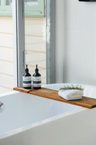 a bathroom counter with two bottles on a shelf at The Avenue in Anglesea