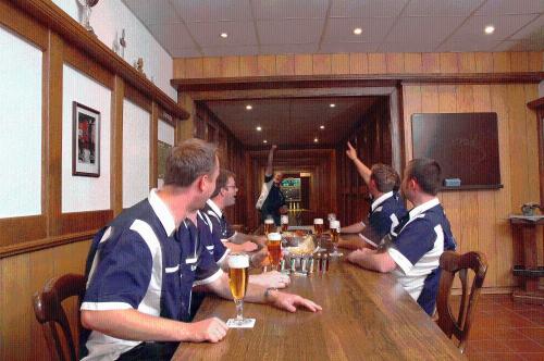 a group of men sitting at a table with beer at Müllers Landhotel in Medebach