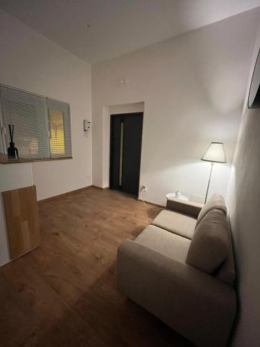 a living room with a couch and a lamp at La Terrazza in centro in Marsala
