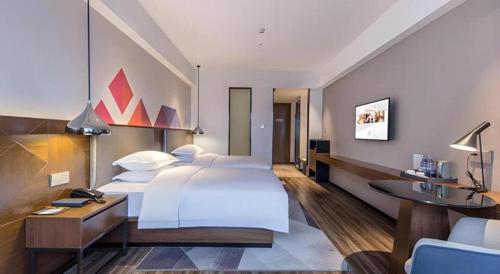 Ένα ή περισσότερα κρεβάτια σε δωμάτιο στο Borrman Hotel Nanning Railway Station