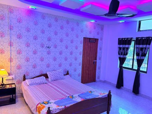 a bedroom with a bed and a purple ceiling at Cozy Nest in Guwahati