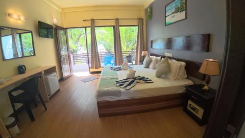 a bedroom with a bed with towels on it at Liberty Guesthouse Maldives in Mahibadhoo