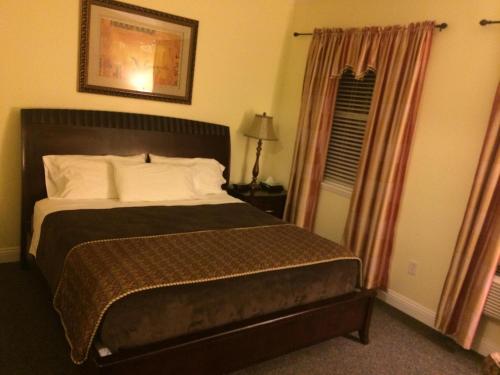 a bedroom with a large bed and a window at The City Hotel Bar & Grill in Northern Cambria