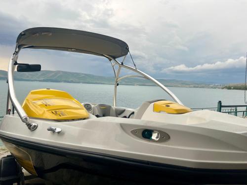 a white boat sitting on top of a body of water at Blue Panorama Sevan in Sevan
