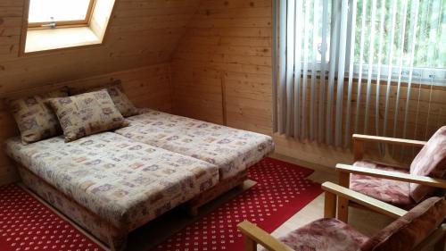 a small bedroom with a bed and a window at Dom na Mazurach in Spychowo