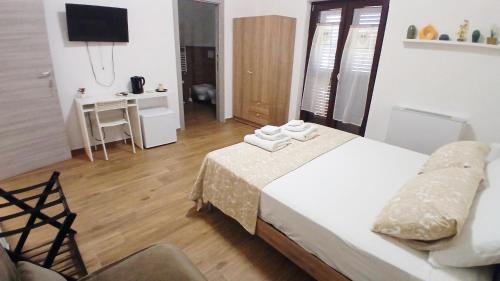 a bedroom with a bed and a desk and a television at Regina di Puglia in Santeramo in Colle