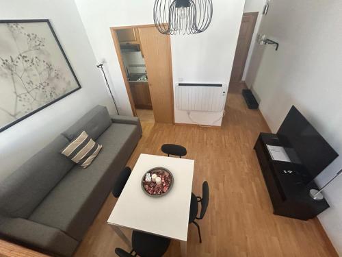 a living room with a couch and a table at Fuente del Tesoro Apartment in Granada