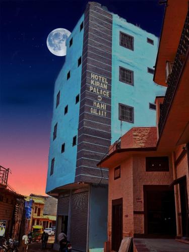 a building with a sign on the side of it at Hotel Kiran Palace and Mahi Galaxy in Osiān