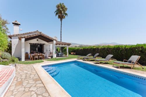 a villa with a swimming pool and a gazebo at Villa Caty in Jimena de la Frontera