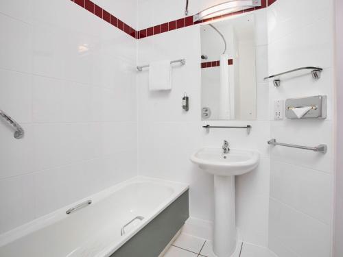 a bathroom with a sink and a toilet and a tub at Leonardo Hotel Nottingham - formerly Jurys Inn in Nottingham