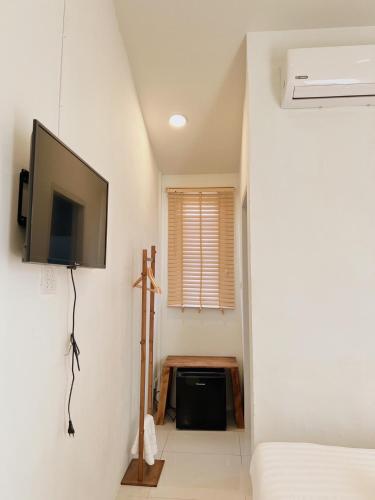 a room with a flat screen tv on a wall at LAIWAII HOME in Hat Yai