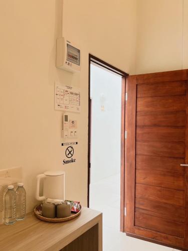 a room with a wooden door and a table at LAIWAII HOME in Hat Yai