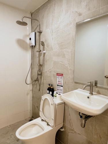 a bathroom with a toilet and a sink at LAIWAII HOME in Hat Yai