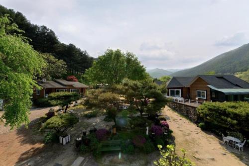 a garden in front of a house with flowers at Pensyeon Hai in Chuncheon