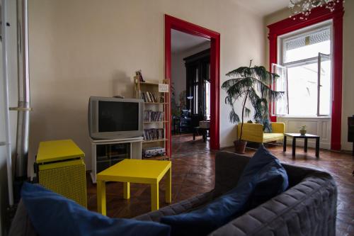 a living room filled with furniture and a tv at Pal's Hostel and Apartments in Budapest