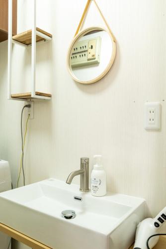a bathroom with a sink and a mirror at 大和の宿 Kitakyobate in Nara