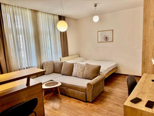 a living room with a couch and a bed at Vila Mila in Sarajevo