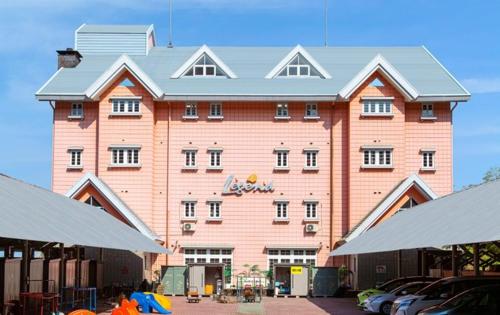 a large pink building with cars parked in front of it at Ikaho Kids Paradise Hotel - Vacation STAY 56430v in Shibukawa