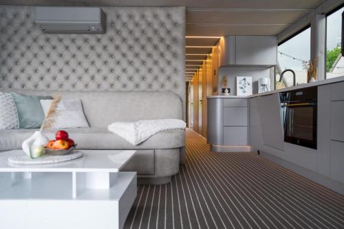 a living room with a couch and a table at Lieblingsplatz Parey - schwimmendes Living Luxboot in Parey