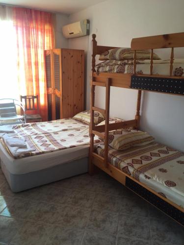 a bedroom with two bunk beds and a window at Complex Laguna-Kantardzhiev in Primorsko