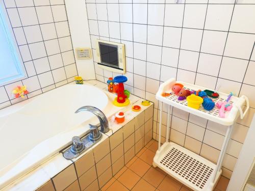 a bathroom with a tub and a sink at Ikaho Kids Paradise Hotel - Vacation STAY 56072v in Shibukawa