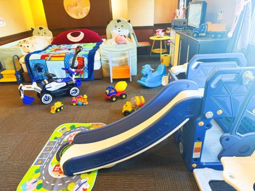 a childs bedroom with a bed and a slide at Ikaho Kids Paradise Hotel - Vacation STAY 56072v in Shibukawa